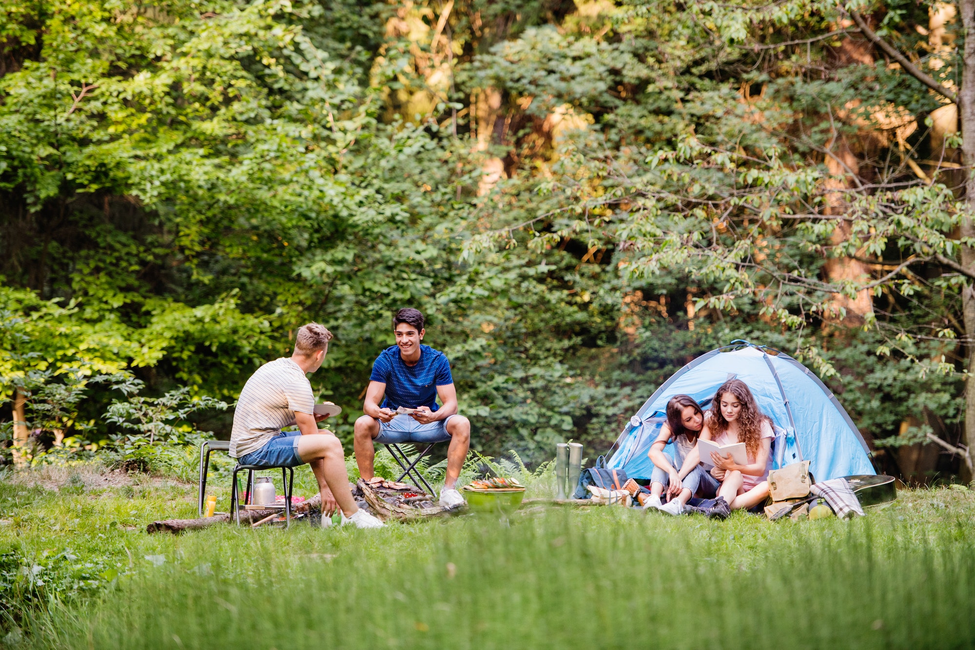 teenagers-camping-in-forest-summer-adventure-.jpg